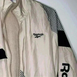 Reebok light pink windbreaker with black and white stripes jacket